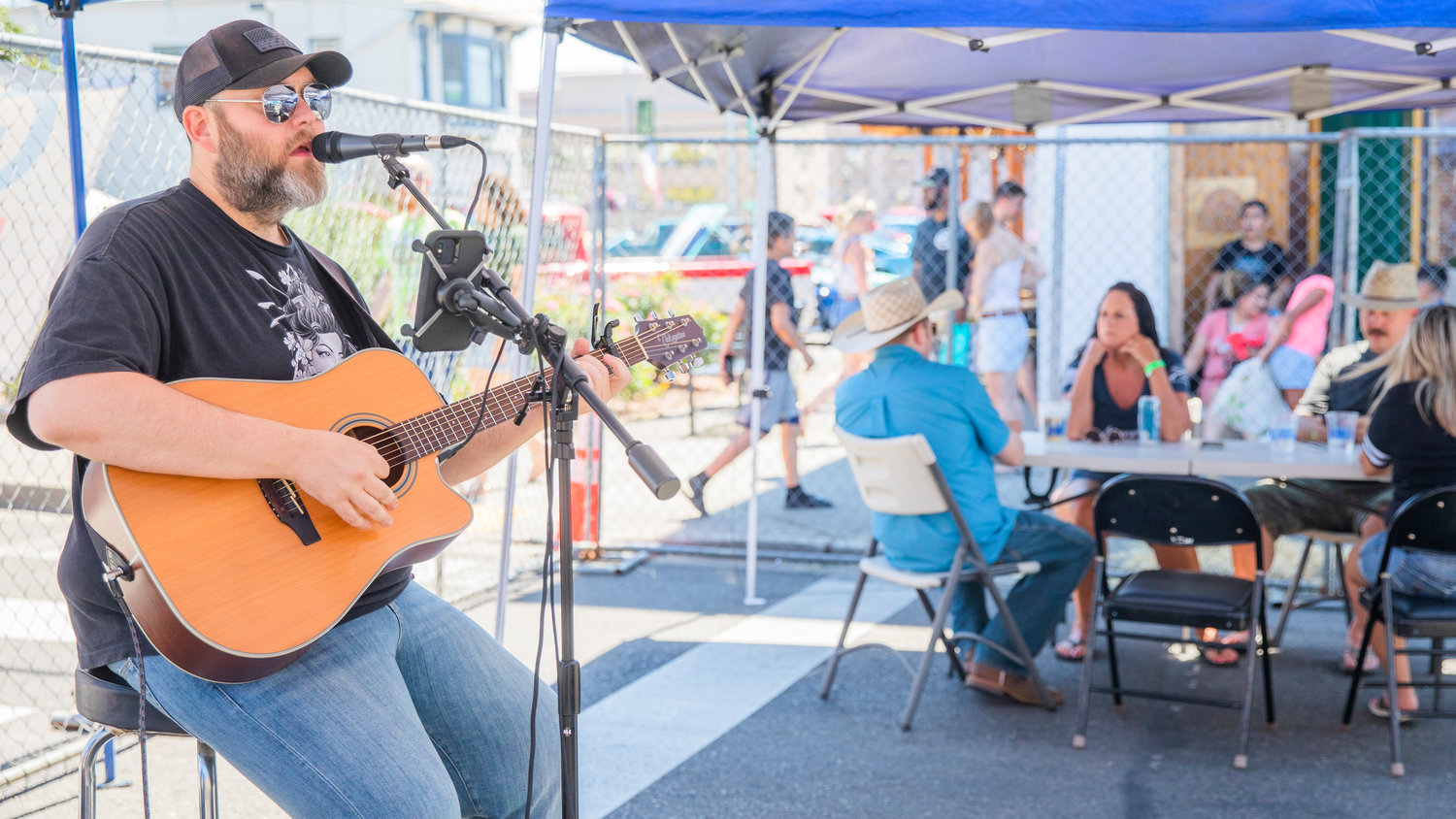 Jeremiah sings and plays guitar as visitors mingle downtown during Chehalis Fest Saturday afternoon.